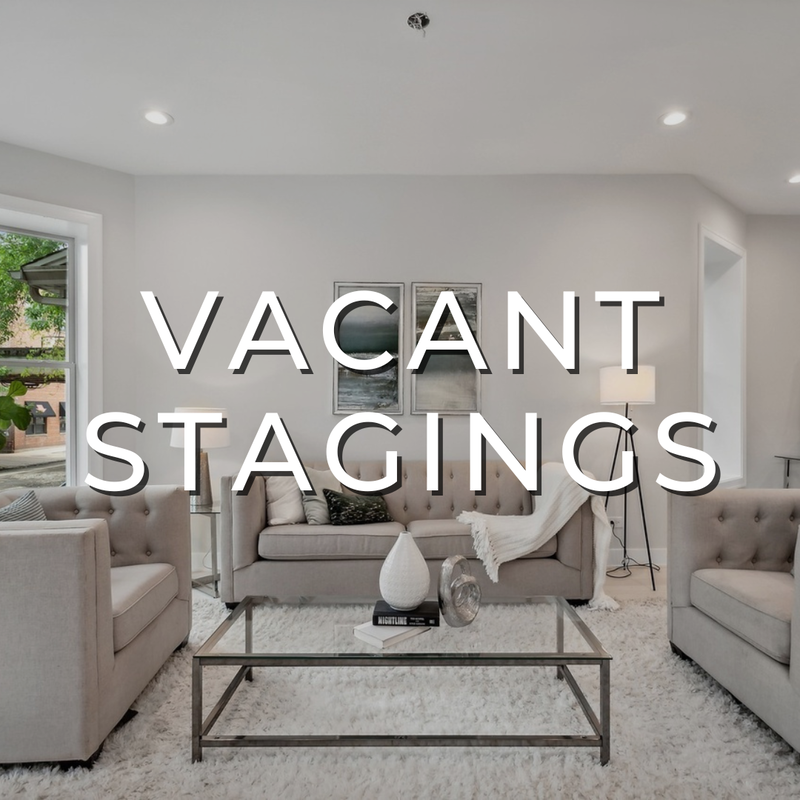 Alt text: A contemporary living room staging with puckered sofas and chairs, a chrome and glass coffee table with accessories, art pair on the wall, a standing lamp, and a white rug. The photo promotes the "Vacant Stagings" webpage and features a shaded background.