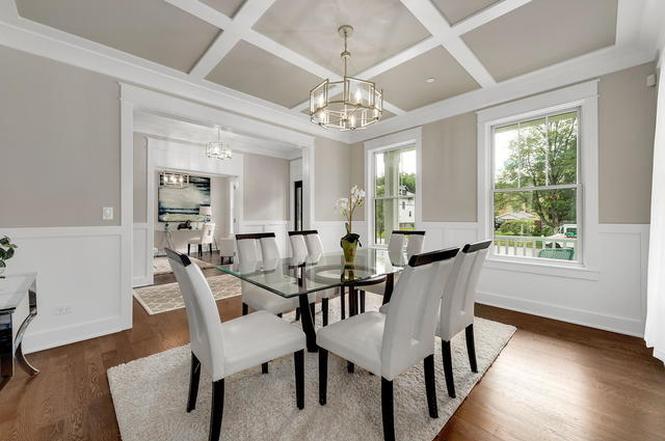 Elegant Evanston dining room with glass table, 6 modern dining chairs, paneled ceiling, and home office in the background.